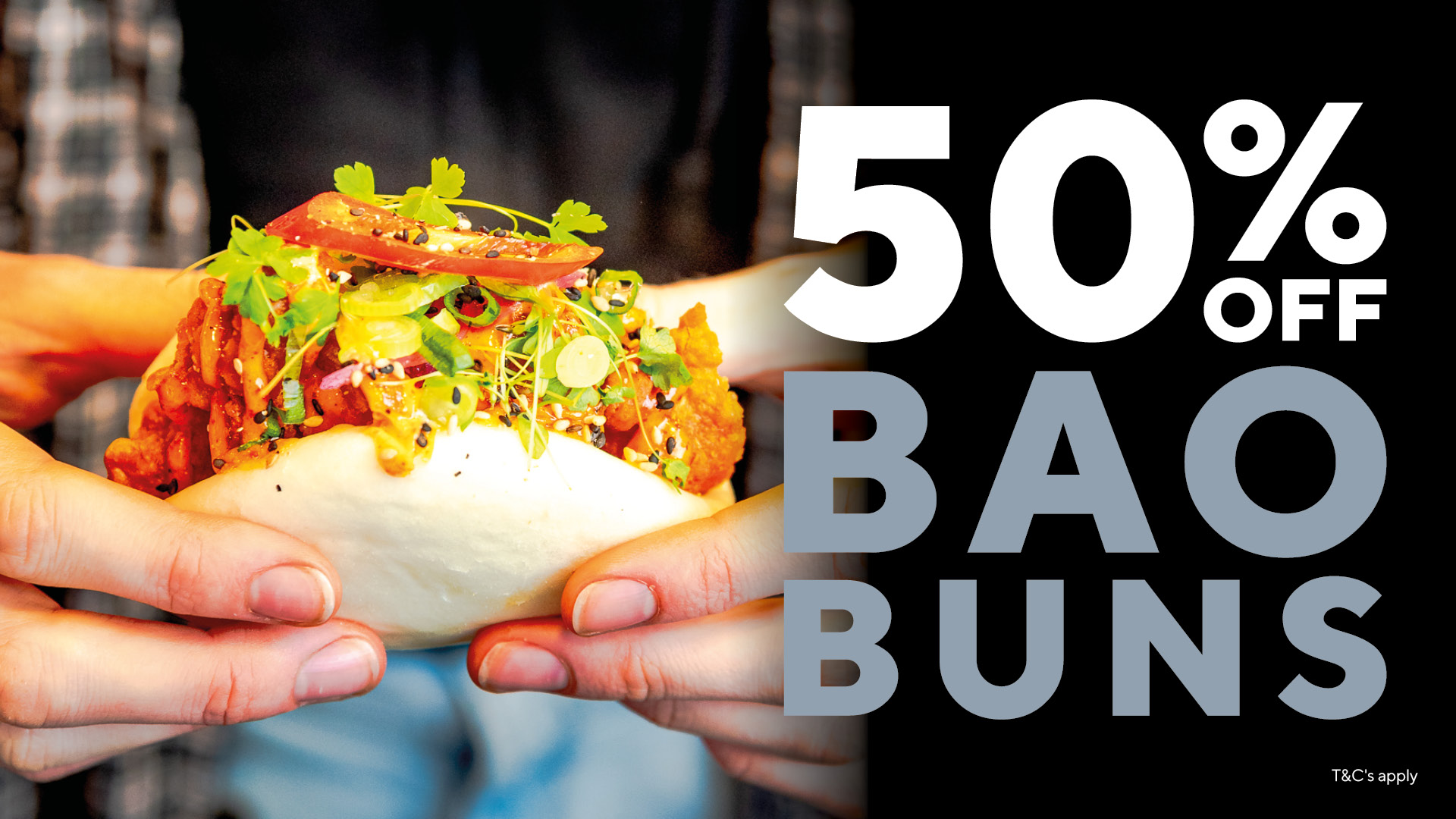 Close-up of hands holding a veggie-filled bao bun; bold 50% OFF BUNS text on the right side of the image.