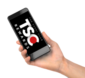 Hand gripping a tilted smartphone; screen shows bold white text on black background with a red seal.